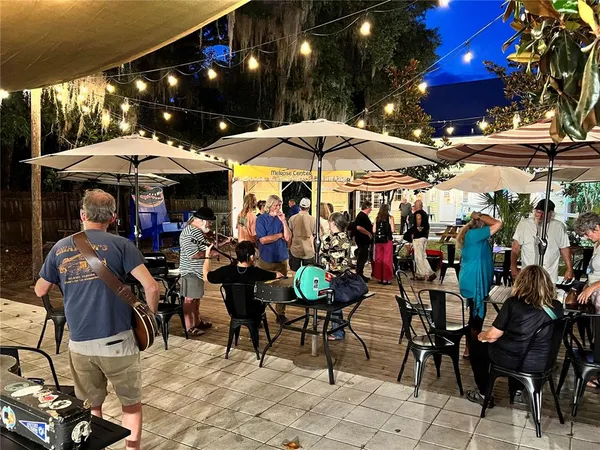 a group of people sitting outside of a city