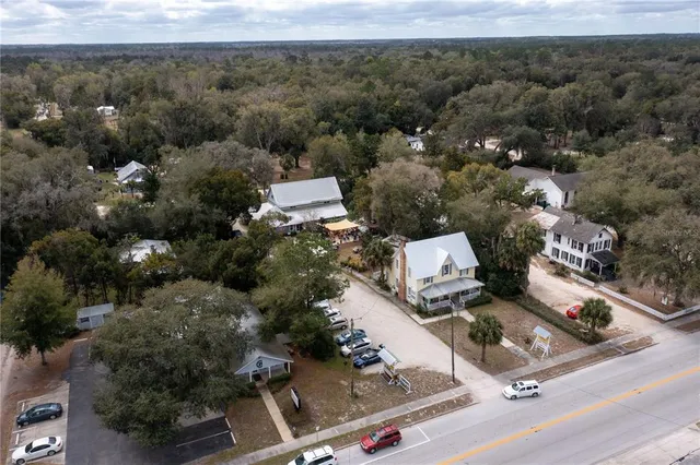 an aerial view of residential houses with outdoor space