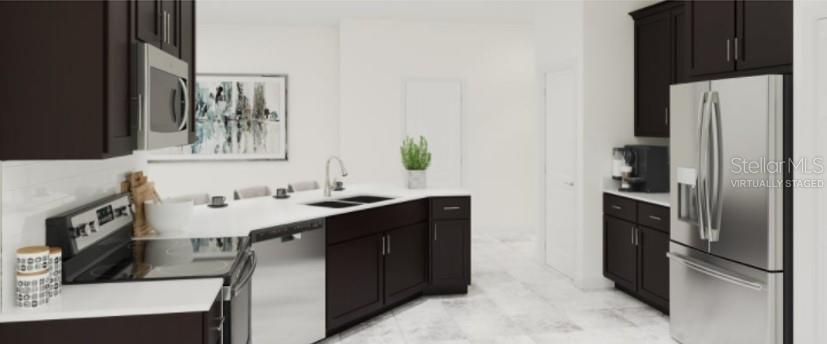 2455 Bluestone Road Haines City, FL 33844 - Photo 2 of 14 a kitchen with stainless steel appliances a sink and a refrigerator