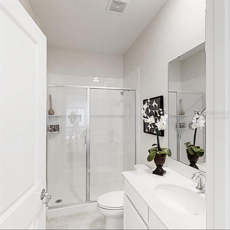 2455 Bluestone Road Haines City, FL 33844 - Photo 8 of 14 a bathroom with a sink a toilet and shower