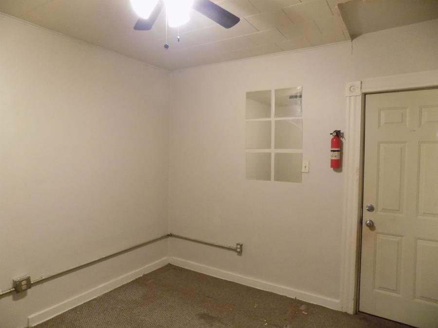 304 Helen Street McKees Rocks, PA 15136 - Photo 11 of 11 an empty room with a ceiling fan and a window