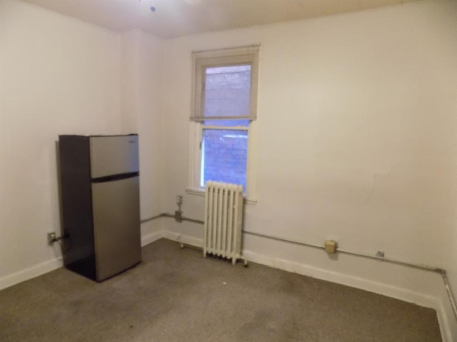 304 Helen Street McKees Rocks, PA 15136 - Photo 2 of 11 a room with a refrigerator and a window