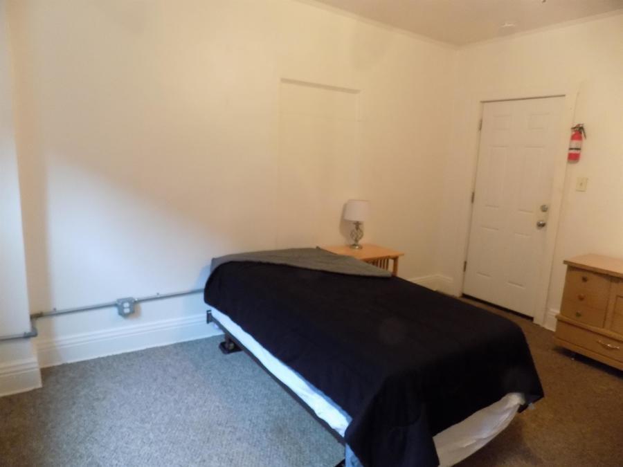 304 Helen Street McKees Rocks, PA 15136 - Photo 3 of 11 a bedroom with a bed and a night stand