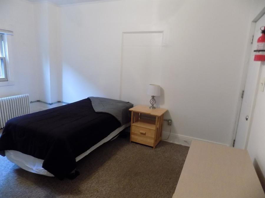 304 Helen Street McKees Rocks, PA 15136 - Photo 6 of 11 a bedroom with a bed and window
