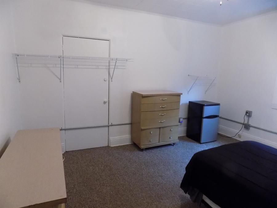 304 Helen Street McKees Rocks, PA 15136 - Photo 10 of 11 a bedroom with a bed and a lamp on desk