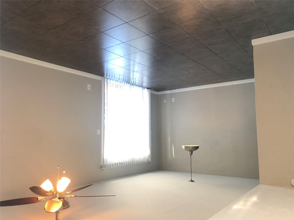 7302 Duval Street, Unit 141 Austin, TX 78752 - Photo 2 of 14 en empty room with windows and ceiling fan