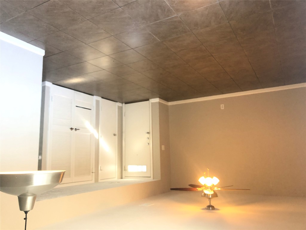 7302 Duval Street, Unit 141 Austin, TX 78752 - Photo 4 of 14 an empty room with a bathroom and a mirror