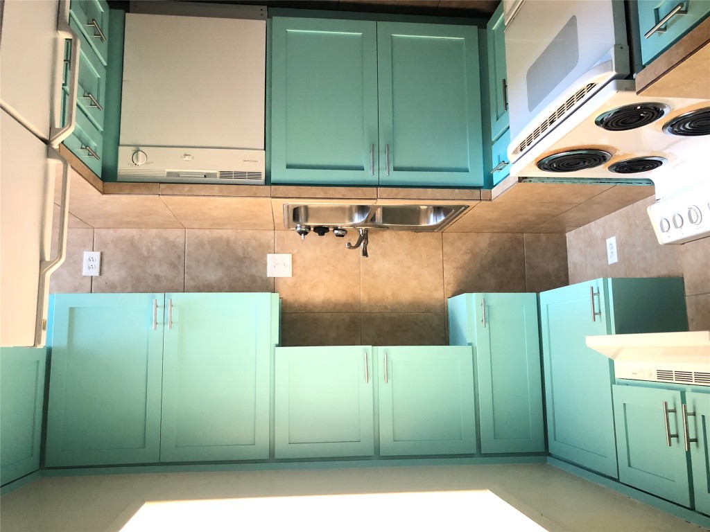 7302 Duval Street, Unit 141 Austin, TX 78752 - Photo 5 of 14 a kitchen with a sink and a stove top oven