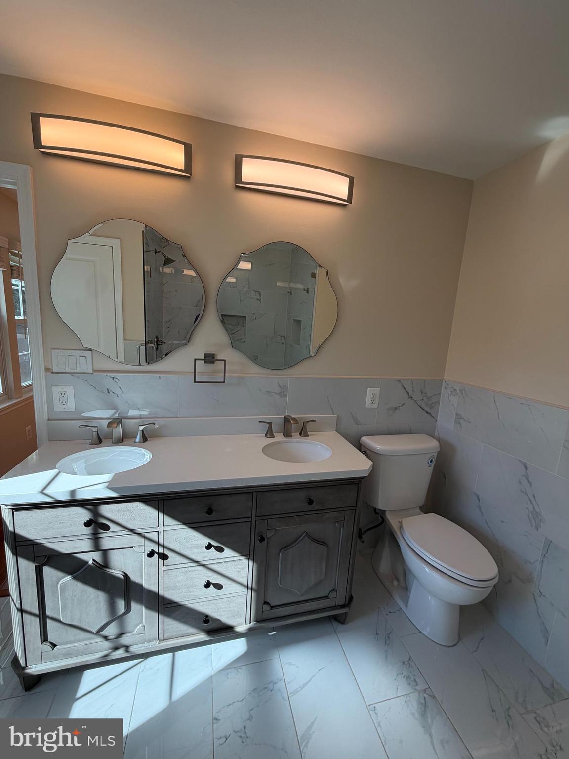 13952 Bishops Bequest Road Upper Marlboro, MD 20772 - Photo 18 of 28 a bathroom with a toilet a sink and mirror