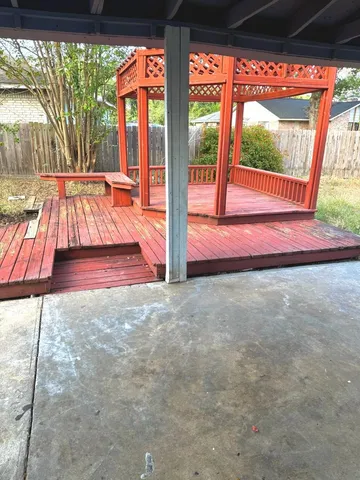 a view of empty room with wooden floor and floor to ceiling window