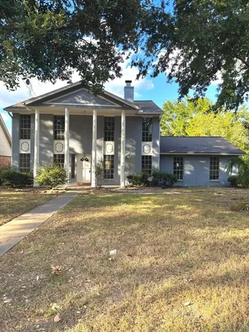 a front view of a house with a garden and porch