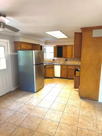 a kitchen with stainless steel appliances granite countertop a refrigerator and a stove top oven