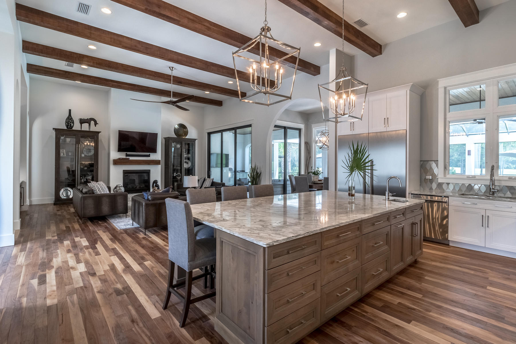 3522 Burnt Pine Lane Miramar Beach, FL 32550 - Photo 16 of 54 a room with kitchen island granite countertop lots of wooden furniture a sink and a large window