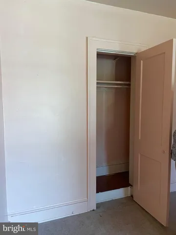 a view of a green field with wooden fence