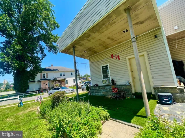 a view of a patio with table and chairs under an umbrella
