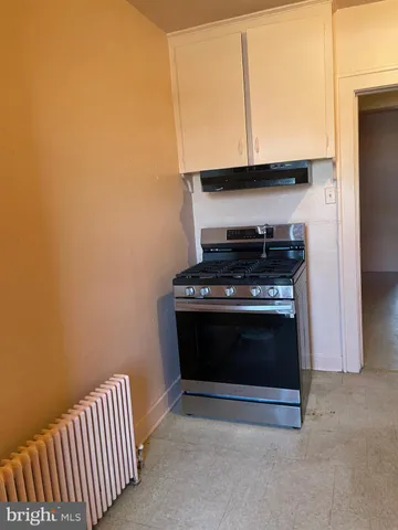 a stove top oven sitting inside of a kitchen