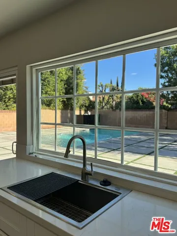 a kitchen with a sink and large window