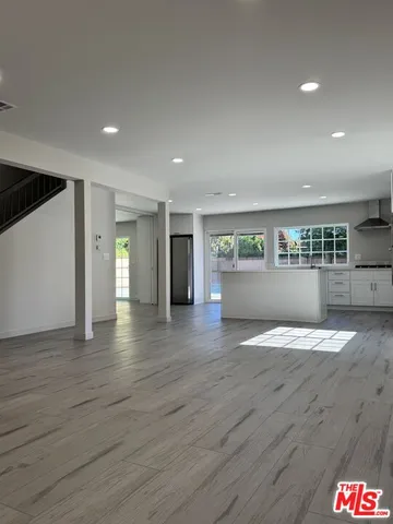 a view of wooden floor and a window in a room