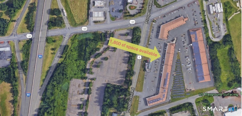 an aerial view of a residential apartment building with a yard