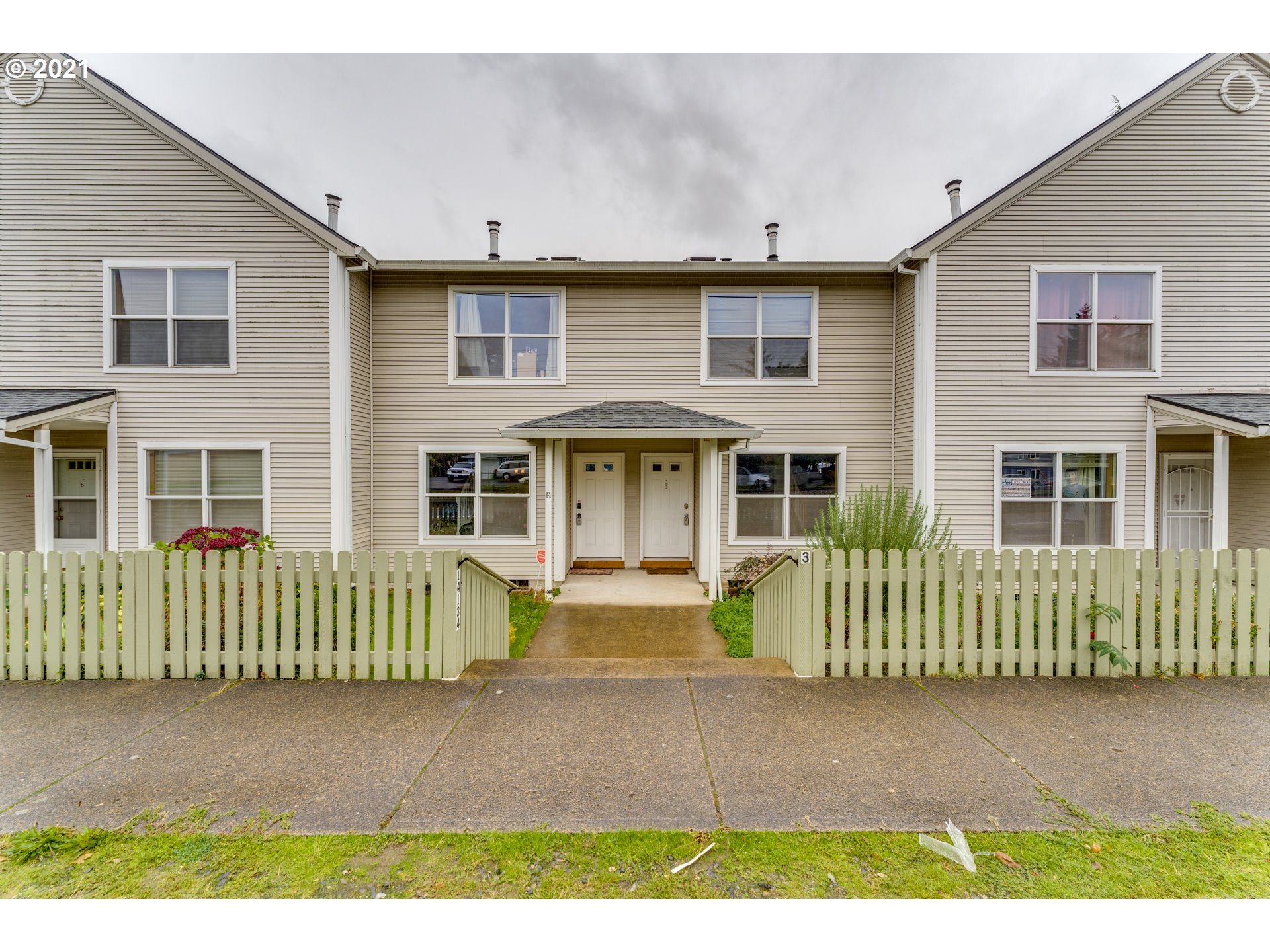 14134 East Burnside Street, Unit 4 Portland, OR 97233 - Photo 1 of 27 a front view of a house with a garden