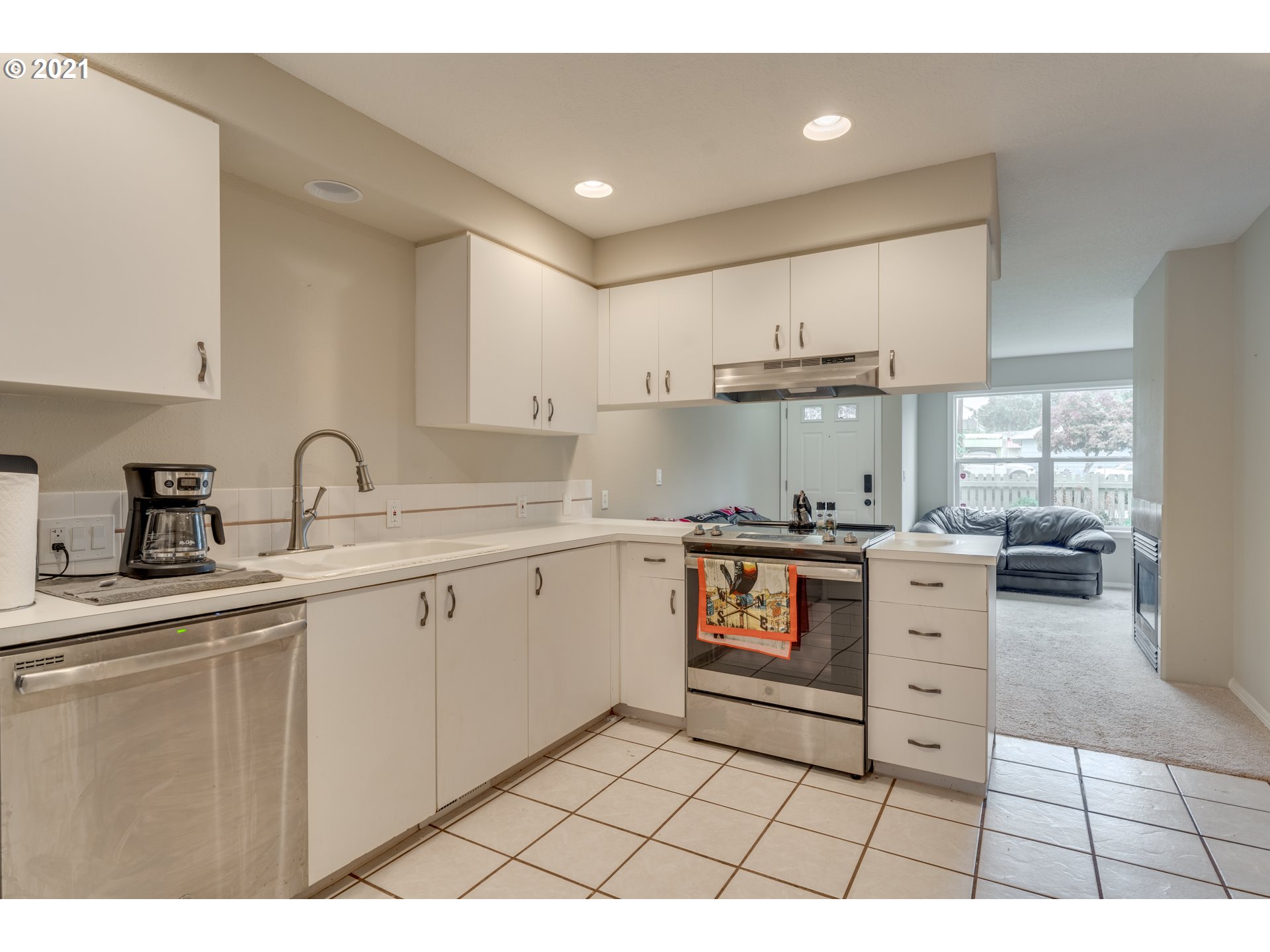 14134 East Burnside Street, Unit 4 Portland, OR 97233 - Photo 11 of 27 a kitchen with a stove a sink and a refrigerator
