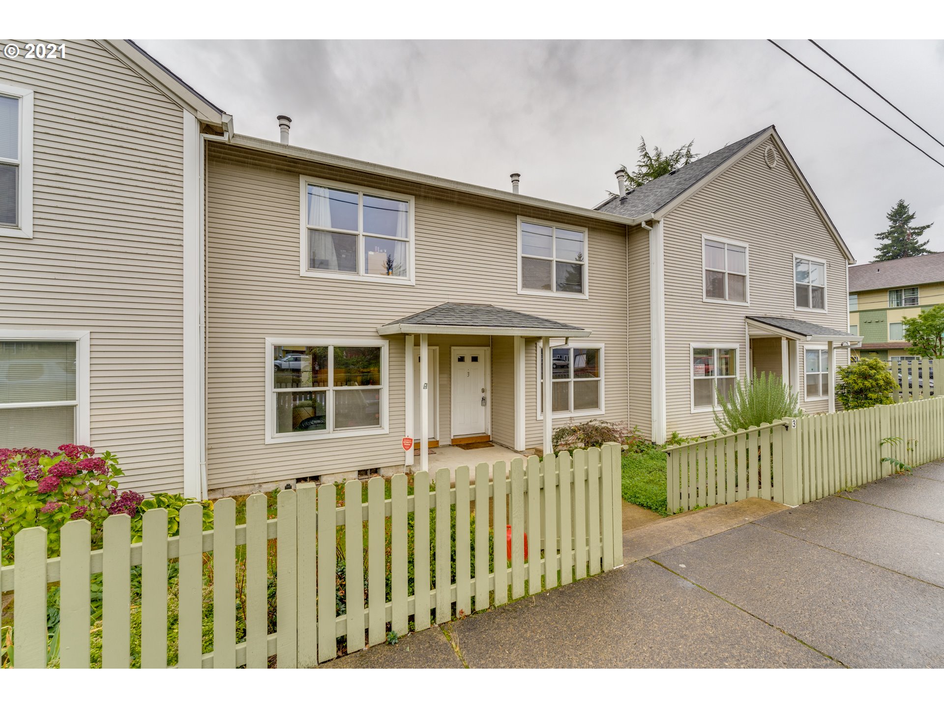 14134 East Burnside Street, Unit 4 Portland, OR 97233 - Photo 13 of 27 a front view of a house with a garden