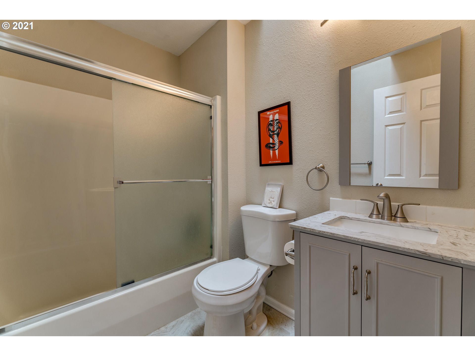 14134 East Burnside Street, Unit 4 Portland, OR 97233 - Photo 19 of 27 a bathroom with a granite countertop toilet a sink and a mirror