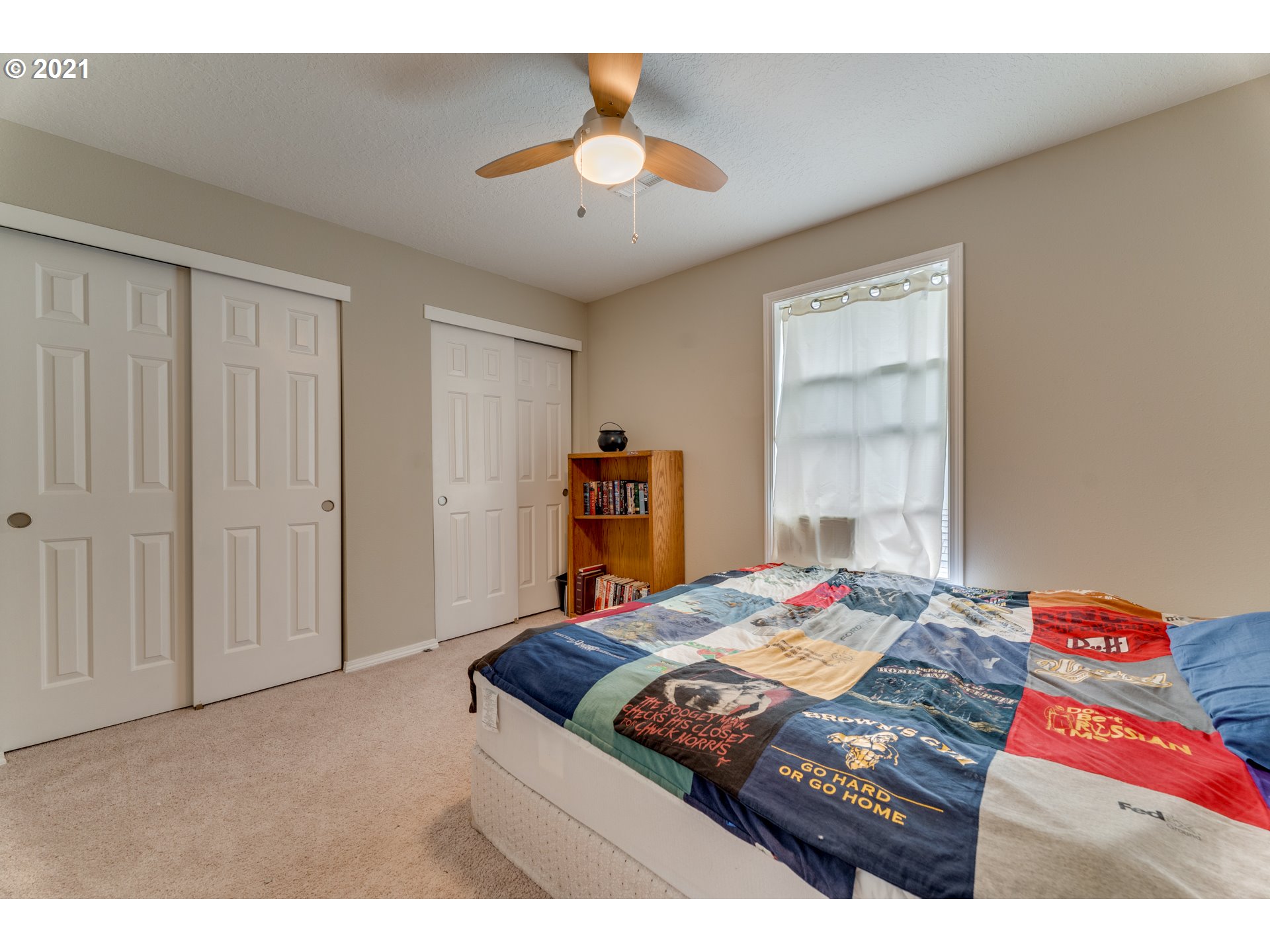 14134 East Burnside Street, Unit 4 Portland, OR 97233 - Photo 20 of 27 a bedroom with a bed and a chandelier