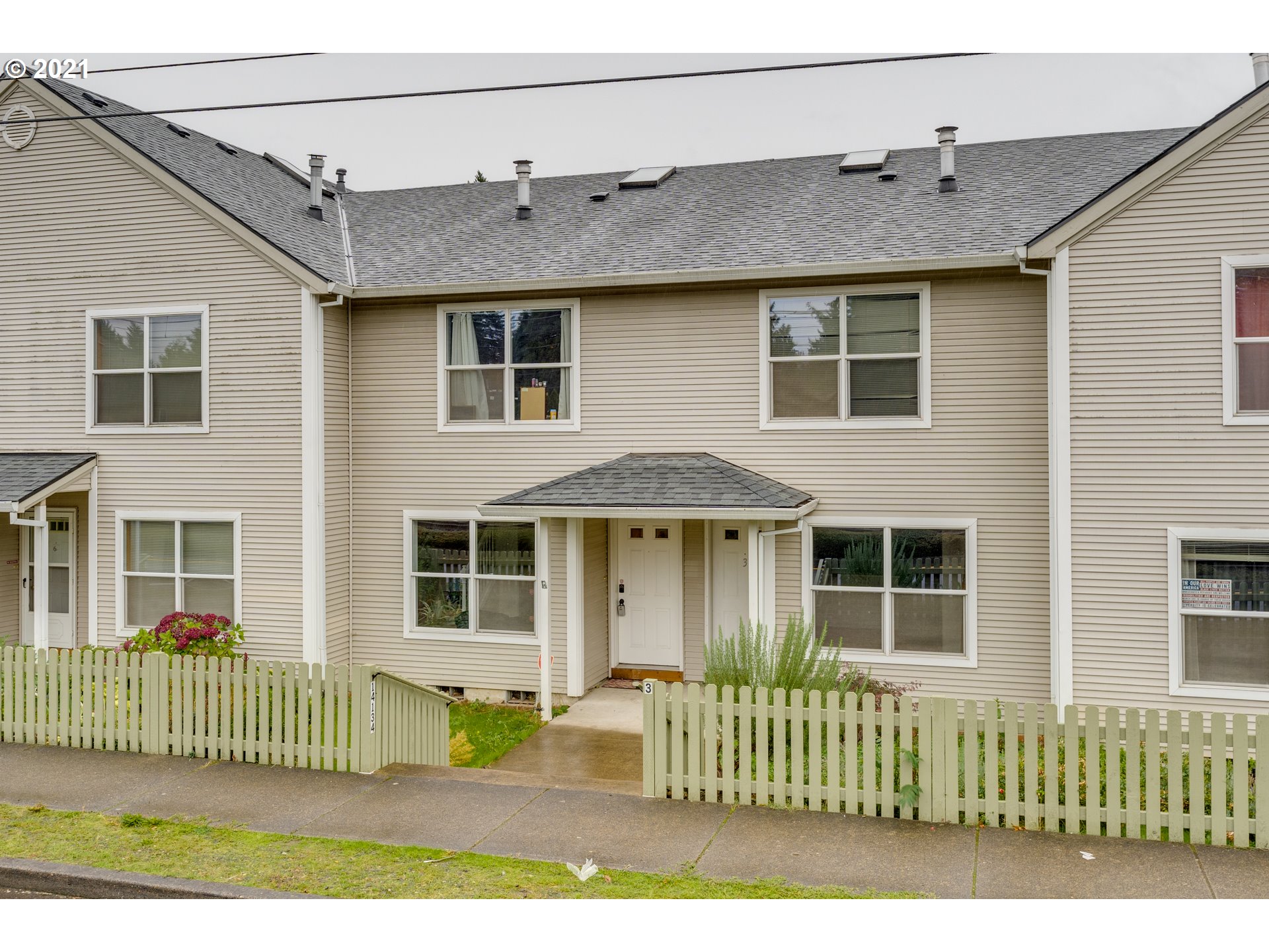 14134 East Burnside Street, Unit 4 Portland, OR 97233 - Photo 26 of 27 a front view of a house with a garden
