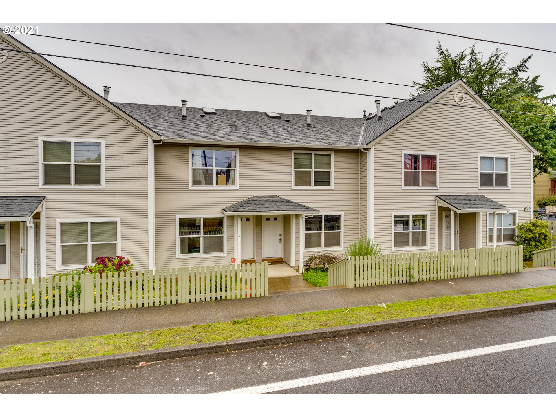 14134 East Burnside Street, Unit 4 Portland, OR 97233 - Photo 27 of 27 a front view of a house with a yard