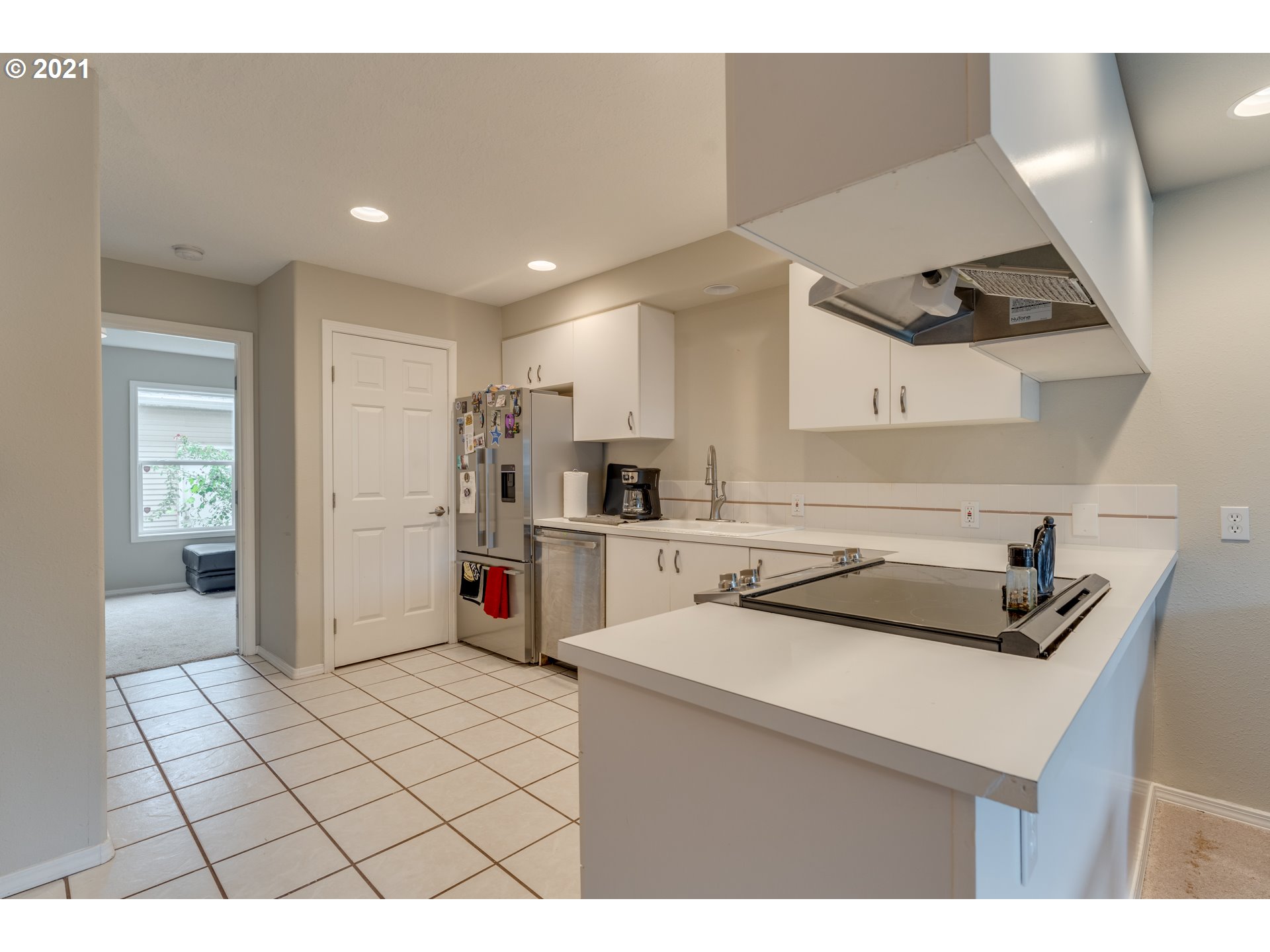 14134 East Burnside Street, Unit 4 Portland, OR 97233 - Photo 8 of 27 a kitchen with stainless steel appliances a sink a stove a refrigerator and cabinets