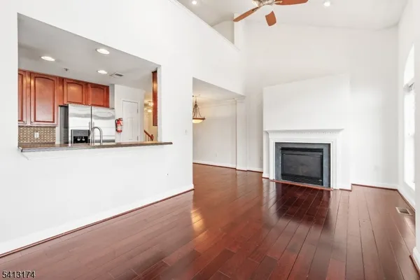 a view of a kitchen with a fridge wooden floor and a window