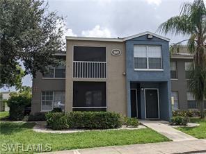142 Santa Clara Drive, Unit 7 Naples, FL 34104 - Photo 1 of 41 View of front of house featuring a front yard and stucco siding