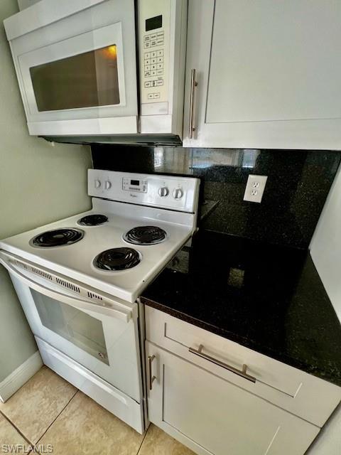 142 Santa Clara Drive, Unit 7 Naples, FL 34104 - Photo 11 of 41 Kitchen with light tile patterned flooring, white cabinetry, white appliances, and backsplash