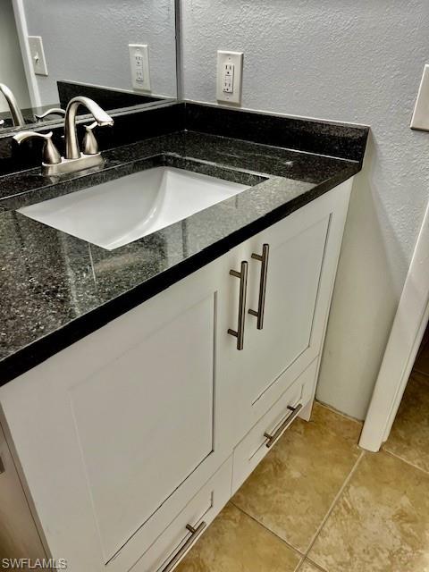 142 Santa Clara Drive, Unit 7 Naples, FL 34104 - Photo 15 of 41 Interior details with a textured wall and vanity