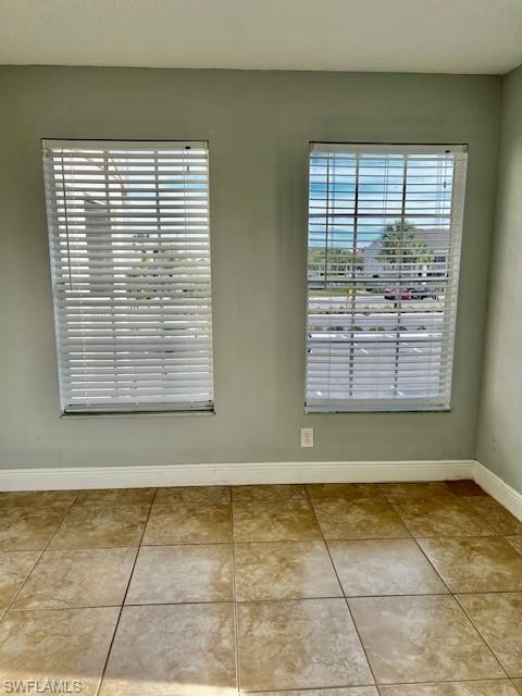 142 Santa Clara Drive, Unit 7 Naples, FL 34104 - Photo 18 of 41 Empty room featuring tile patterned flooring and baseboards