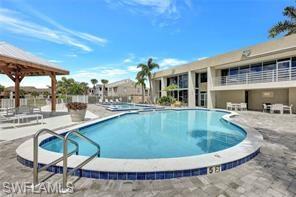 142 Santa Clara Drive, Unit 7 Naples, FL 34104 - Photo 2 of 41 Community pool featuring a gazebo and a patio area