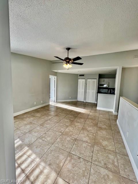 142 Santa Clara Drive, Unit 7 Naples, FL 34104 - Photo 24 of 41 Tiled empty room with a textured ceiling, ceiling fan, and baseboards