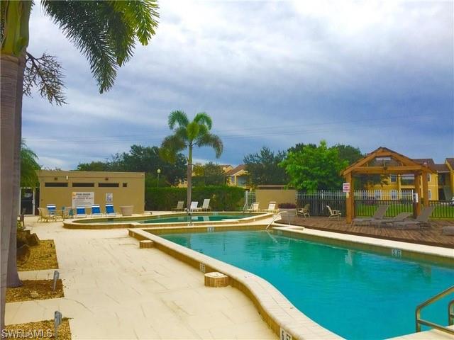 142 Santa Clara Drive, Unit 7 Naples, FL 34104 - Photo 29 of 41 Community pool featuring a gazebo, a patio area, and fence