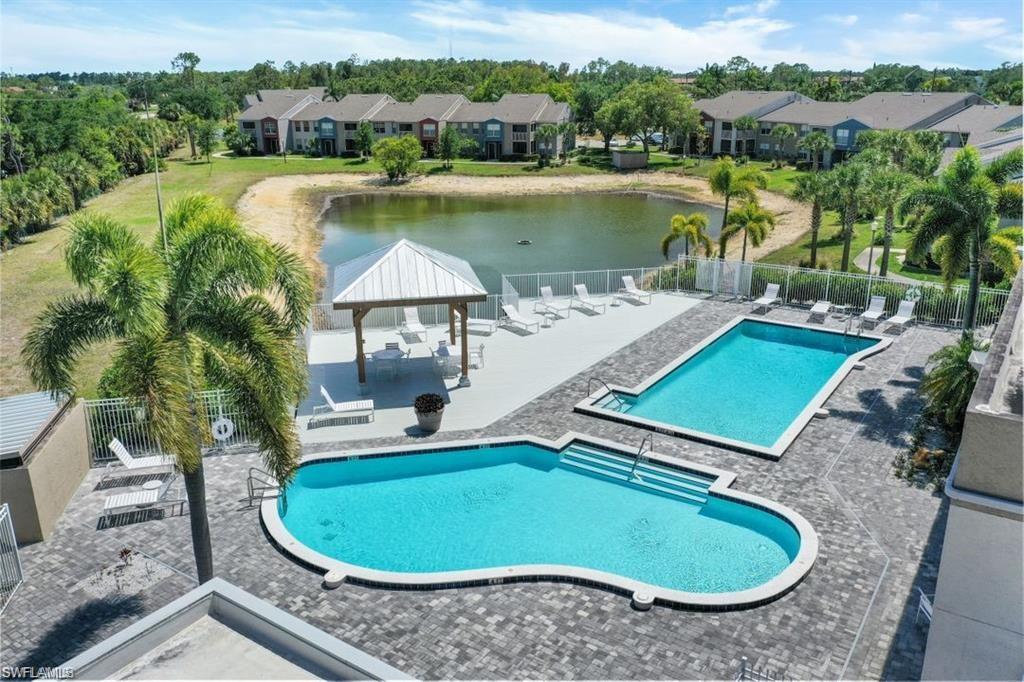 142 Santa Clara Drive, Unit 7 Naples, FL 34104 - Photo 34 of 41 Pool featuring fence, a gazebo, a water view, and a patio