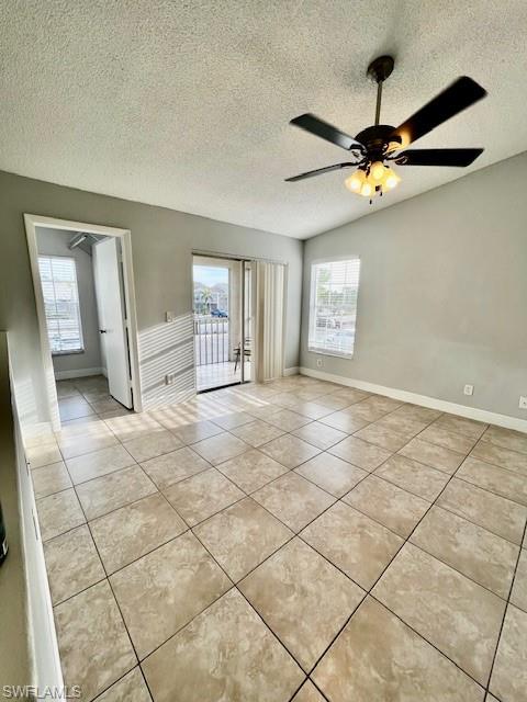 142 Santa Clara Drive, Unit 7 Naples, FL 34104 - Photo 4 of 41 Empty room with light tile patterned flooring, a textured ceiling, ceiling fan, and baseboards