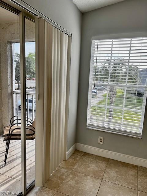 142 Santa Clara Drive, Unit 7 Naples, FL 34104 - Photo 7 of 41 Doorway with light tile patterned flooring and baseboards