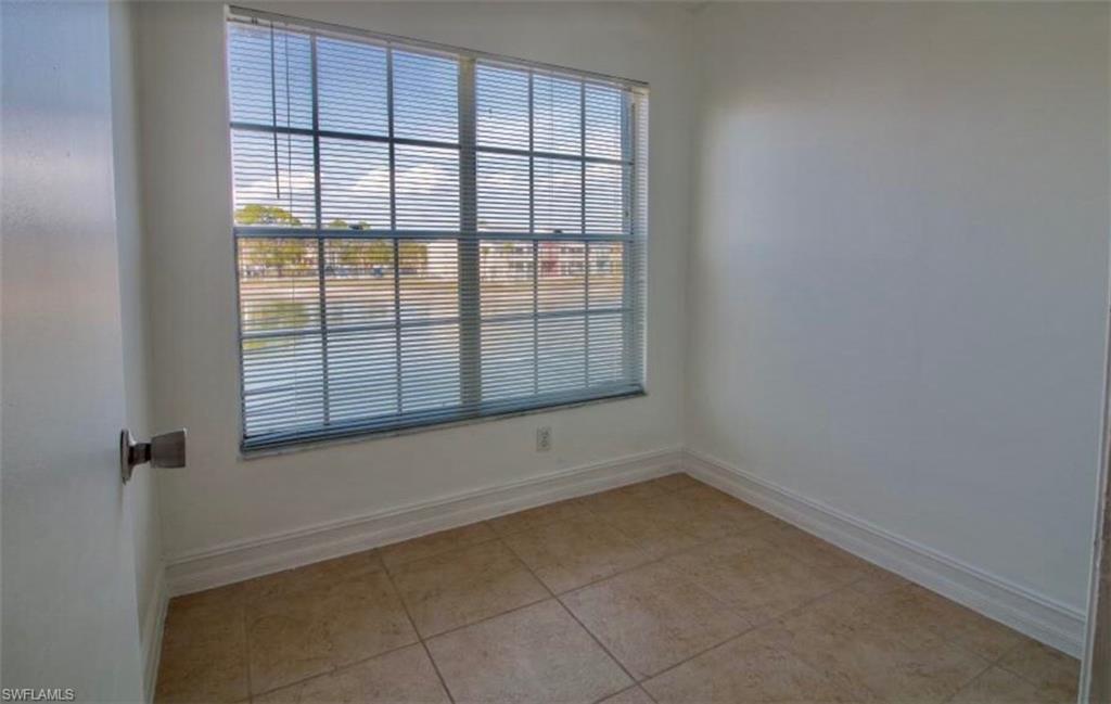 142 Santa Clara Drive, Unit 7 Naples, FL 34104 - Photo 8 of 41 Spare room with baseboards and light tile patterned floors