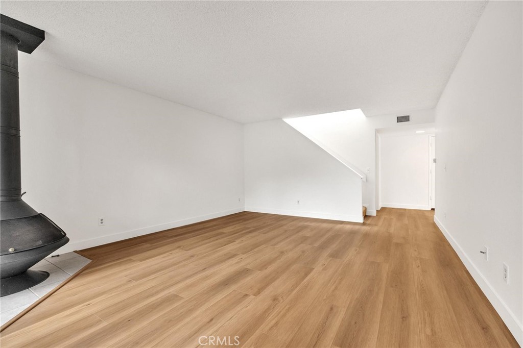 4140 Workman Mill Road, Unit 253 Whittier, CA 90601 - Photo 11 of 63 a view of an empty room and wooden floor