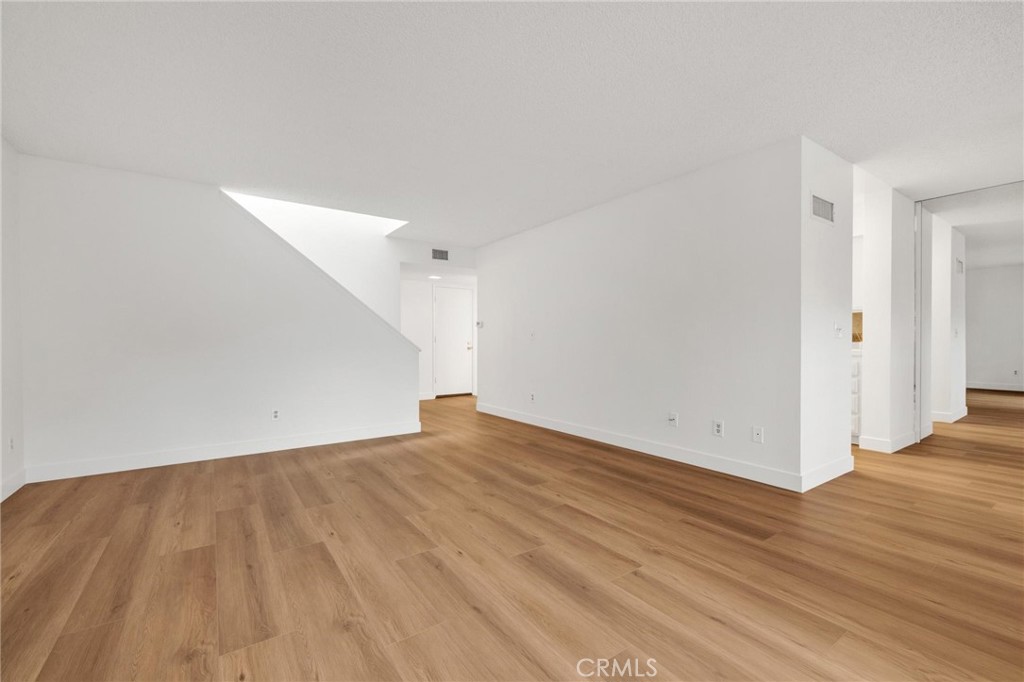 4140 Workman Mill Road, Unit 253 Whittier, CA 90601 - Photo 12 of 63 a view of an empty room with wooden floor