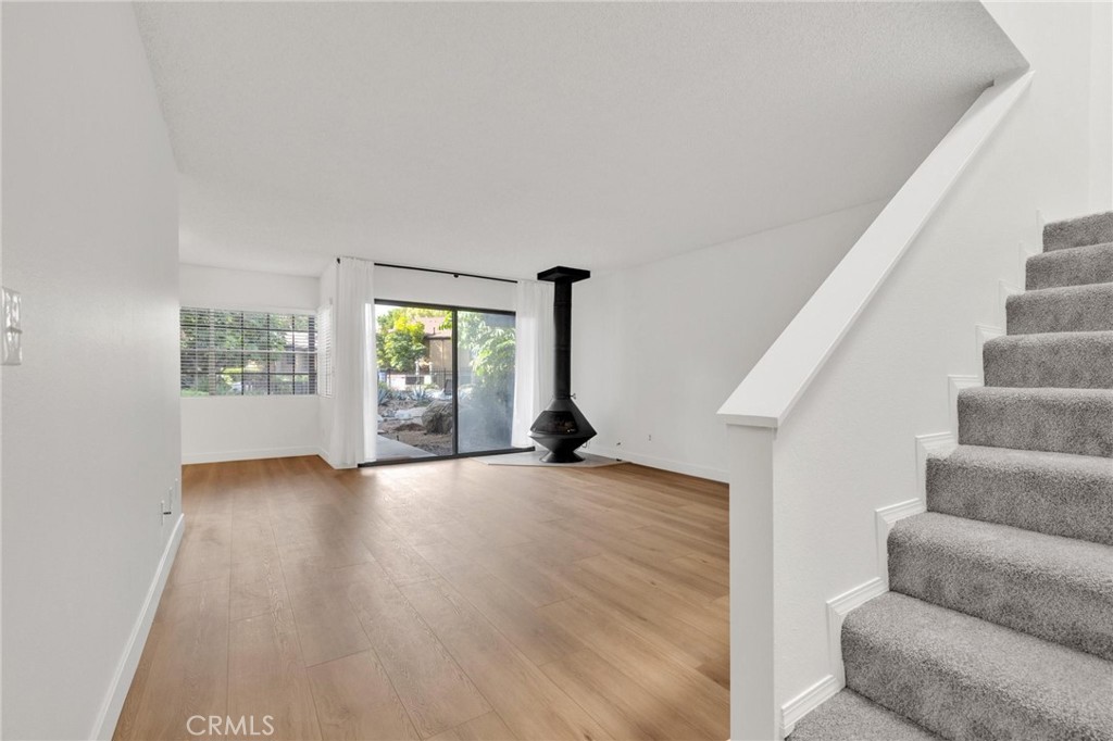 4140 Workman Mill Road, Unit 253 Whittier, CA 90601 - Photo 16 of 63 a view of an empty room with wooden floor and windows