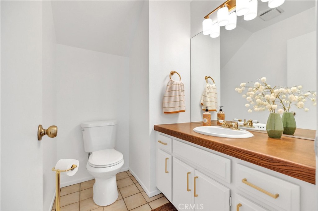 4140 Workman Mill Road, Unit 253 Whittier, CA 90601 - Photo 17 of 63 a bathroom with a granite countertop sink a toilet and a mirror