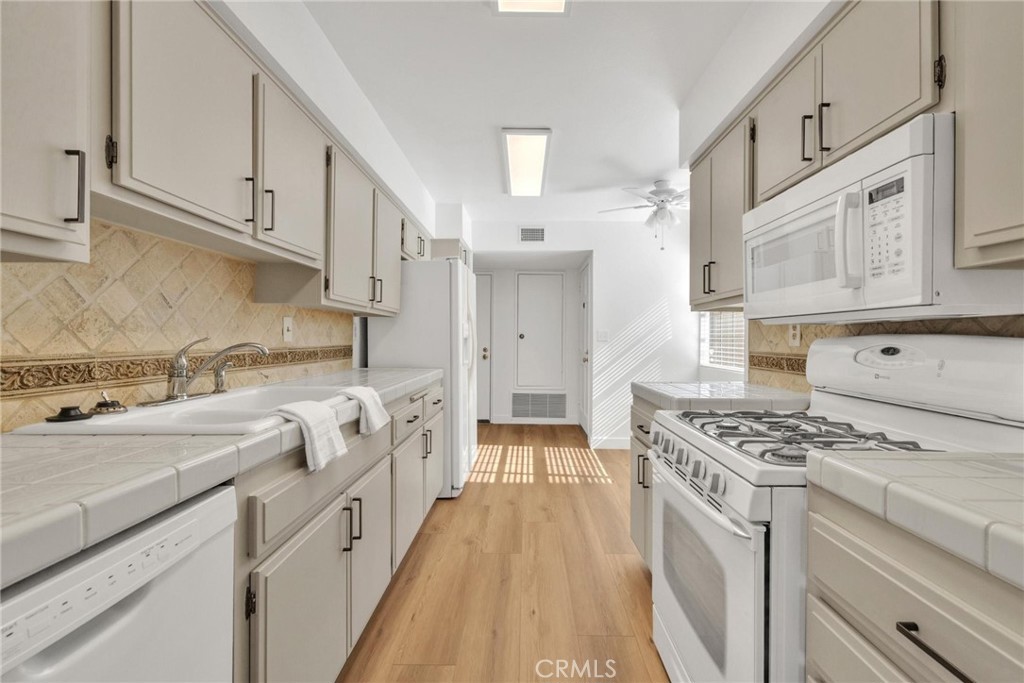 4140 Workman Mill Road, Unit 253 Whittier, CA 90601 - Photo 7 of 63 a kitchen with stainless steel appliances granite countertop a stove and a white cabinets
