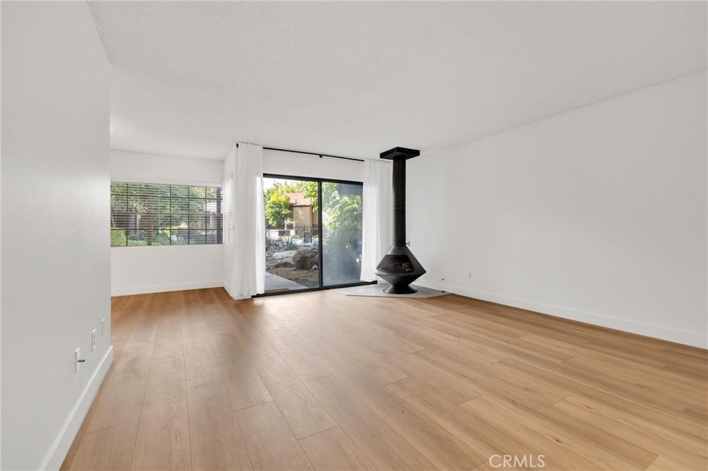 4140 Workman Mill Road, Unit 253 Whittier, CA 90601 - Photo 10 of 63 an empty room with wooden floor and windows
