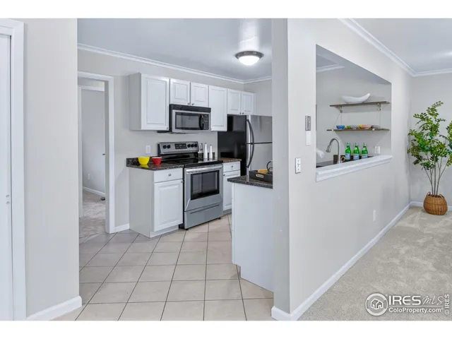 a kitchen with a sink and stainless steel appliances